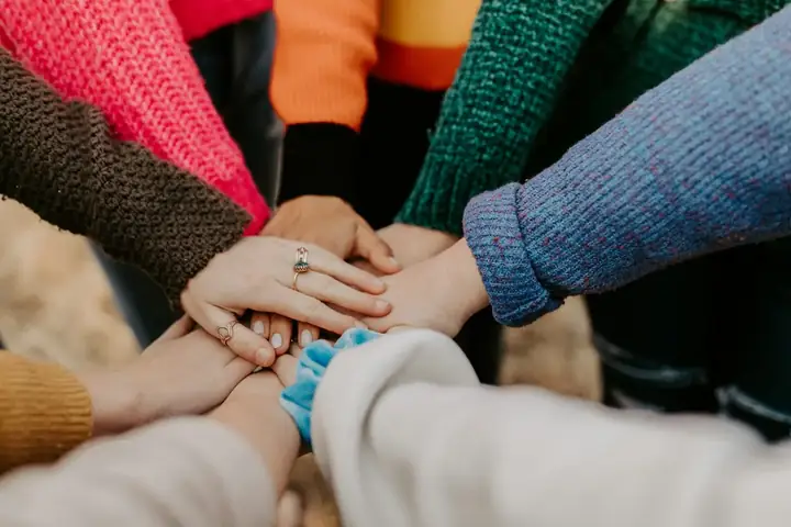 Community members joining hands